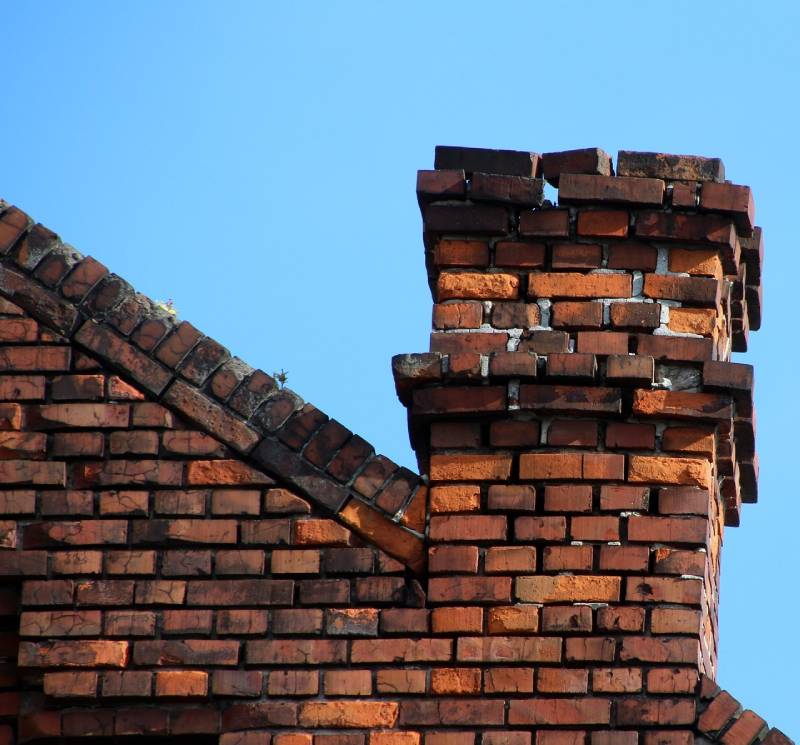 Damaged chimney on an Silver Spring home showing cracks and missing mortar